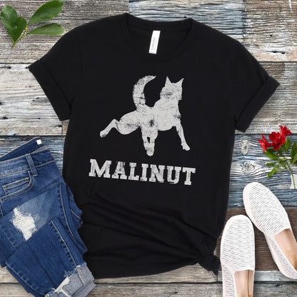 Black dog lover t-shirt with leaping Belgian Malinois silhouette and 'MALINUT' text on a wooden surface with jeans and shoes.