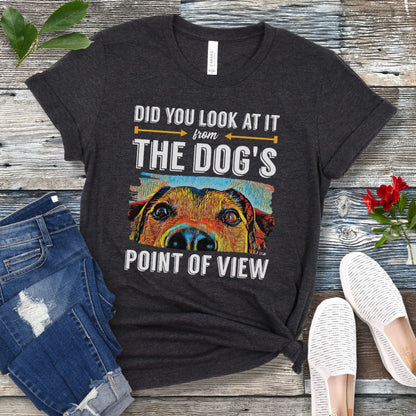 Dark grey dog training t-shirt with colorful dog face graphic and the text 'Did You Look At It From Your Dog's Point of View', laid flat with jeans and white shoes.