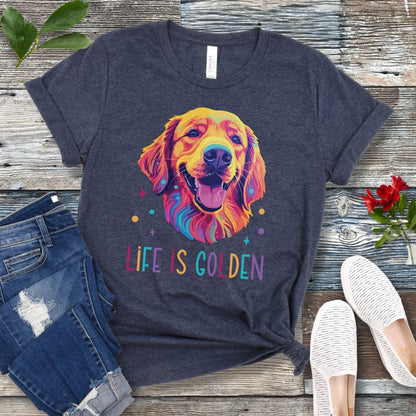 Heather navy t-shirt with colorful Golden Retriever dog graphic and 'Life is Golden' text on a wooden surface with jeans and shoes.