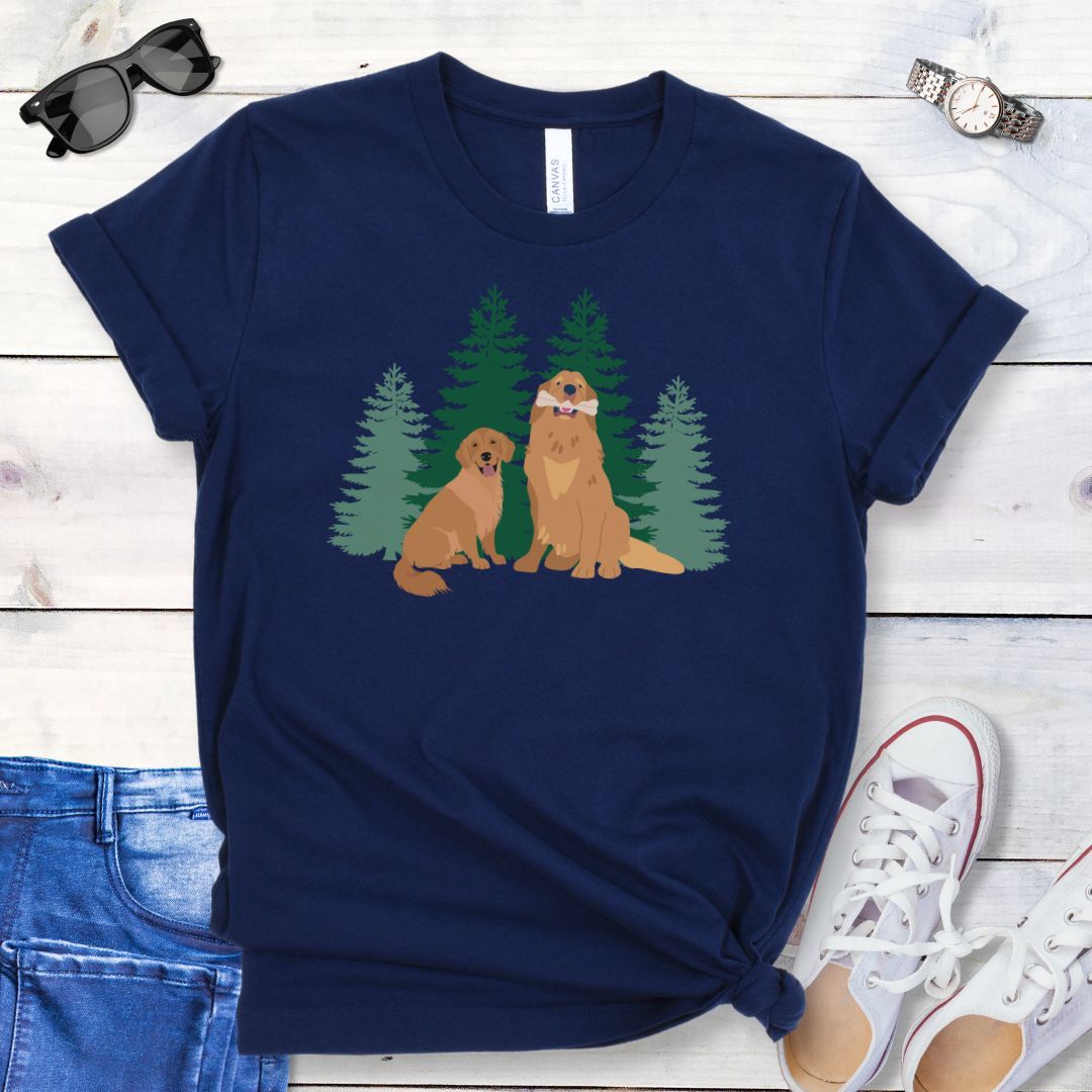 Navy blue dog lover t-shirt with graphic of 2 Golden Retrievers in front of an evergreen forest, shown on a wooden surface with jeans and shoes.