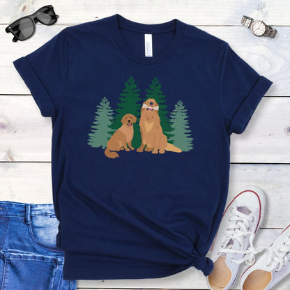 Navy blue dog lover t-shirt with graphic of 2 Golden Retrievers in front of an evergreen forest, shown on a wooden surface with jeans and shoes.