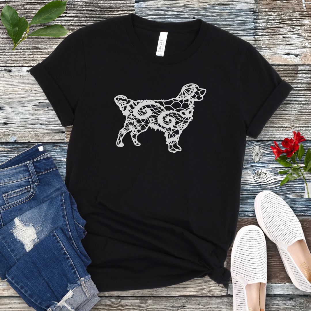 Black t-shirt for Golden dog moms with faux-lace design of a Golden Retriever, shown on a wooden surface with jeans and shoes.