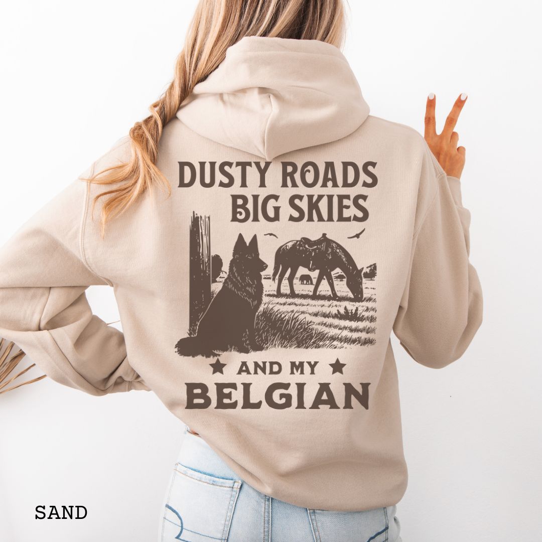 Back view of sand beige hoodie featuring a Western-style design with grazing horse, rustic fence, and a Belgian Sheepdog illustration; text reads “Dusty Roads, Big Skies, and My Belgian.”