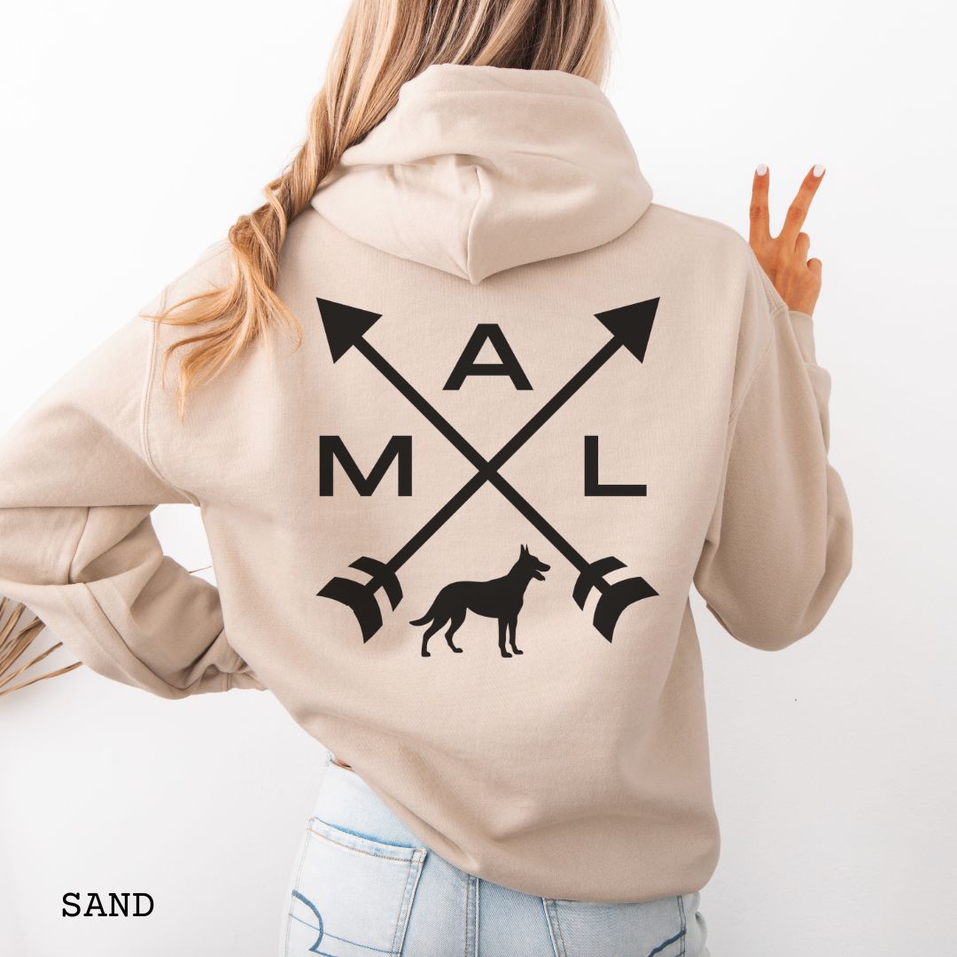 Back view of a beige unisex hoodie with a graphic of crossed arrows, a Belgian Malinois dog, and the text 'MAL', worn by a person.