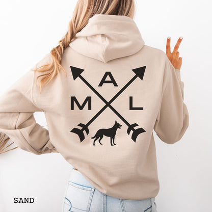 Back view of a beige unisex hoodie with a graphic of crossed arrows, a Belgian Malinois dog, and the text 'MAL', worn by a person.