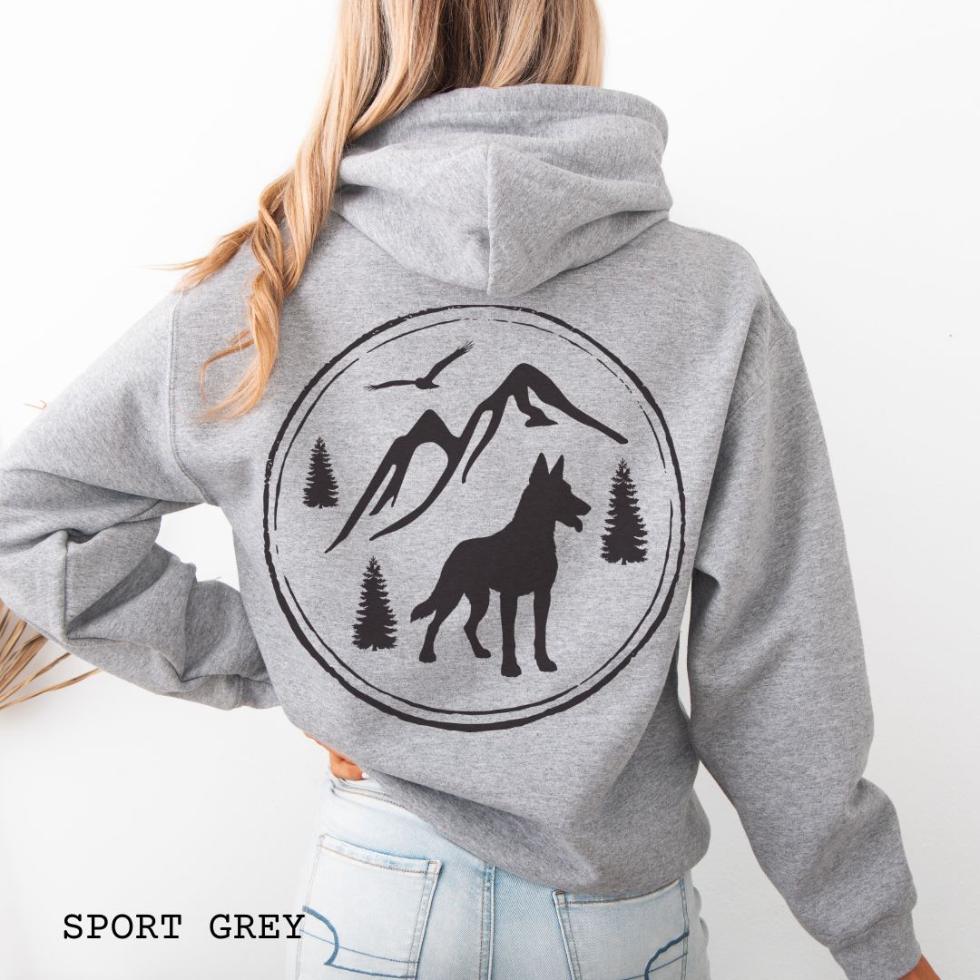 Grey Belgian Malinois hoodie featuring a bold vintage-style back print with Malinois silhouette, mountains, pine trees, perfect gift for hiking and outdoorsy Belgian Shepherd dog lovers.