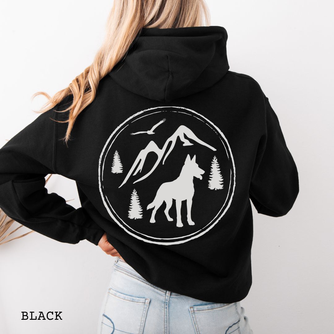 Black Belgian Malinois hoodie featuring a bold vintage-style back print with Malinois silhouette, mountains, pine trees, perfect gift for hiking and outdoorsy Belgian Shepherd dog lovers.