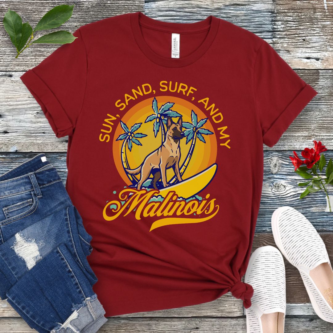 Dark red unisex retro tropical Belgian Malinois beach t-shirt featuring a surfing Malinois with palm trees and sunset design, perfect for Malinois owners, working dog lovers, beach dog moms, and summer adventure fans.