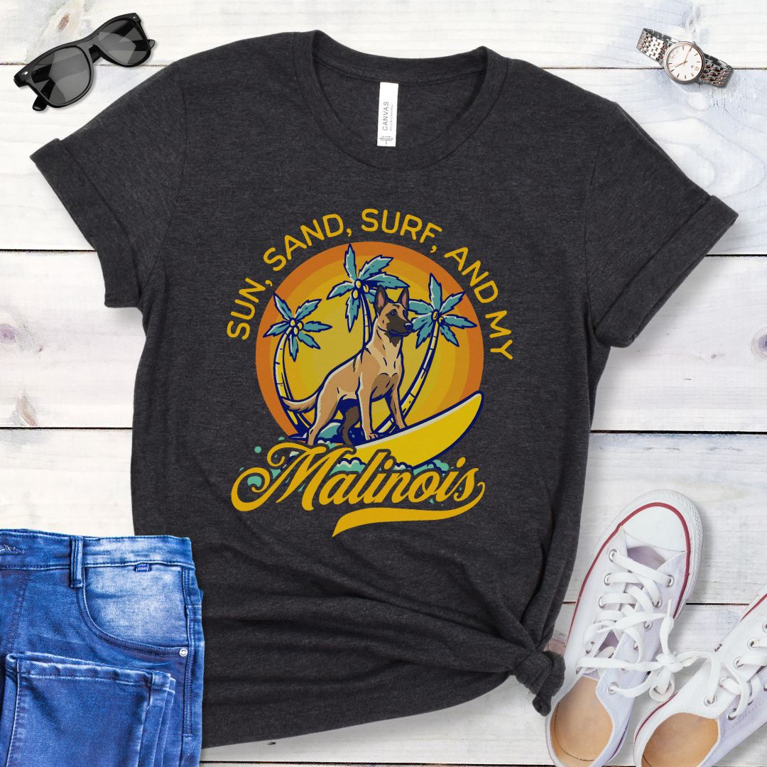 Dark grey unisex retro tropical Belgian Malinois beach t-shirt featuring a surfing Malinois with palm trees and sunset design, perfect for Malinois owners, working dog lovers, beach dog moms, and summer adventure fans.