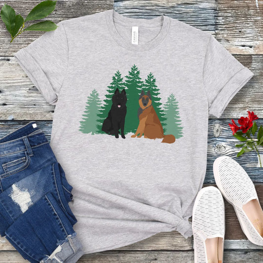 Gray Belgian Shepherd t-shirt with Belgian Sheepdog and Tervuren sitting in front of evergreen trees, shown on a wooden surface with jeans and shoes.