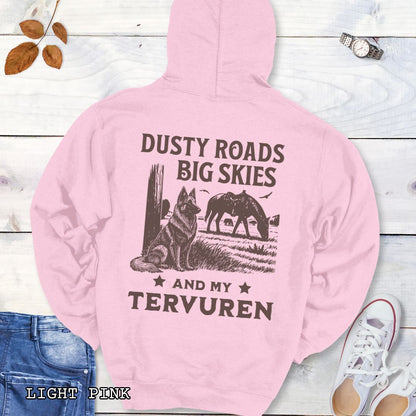Back view of light pink hoodie featuring a Western-style design with grazing horse, rustic fence, and a Belgian Tervuren illustration; text reads “Dusty Roads, Big Skies, and My Tervuren.”