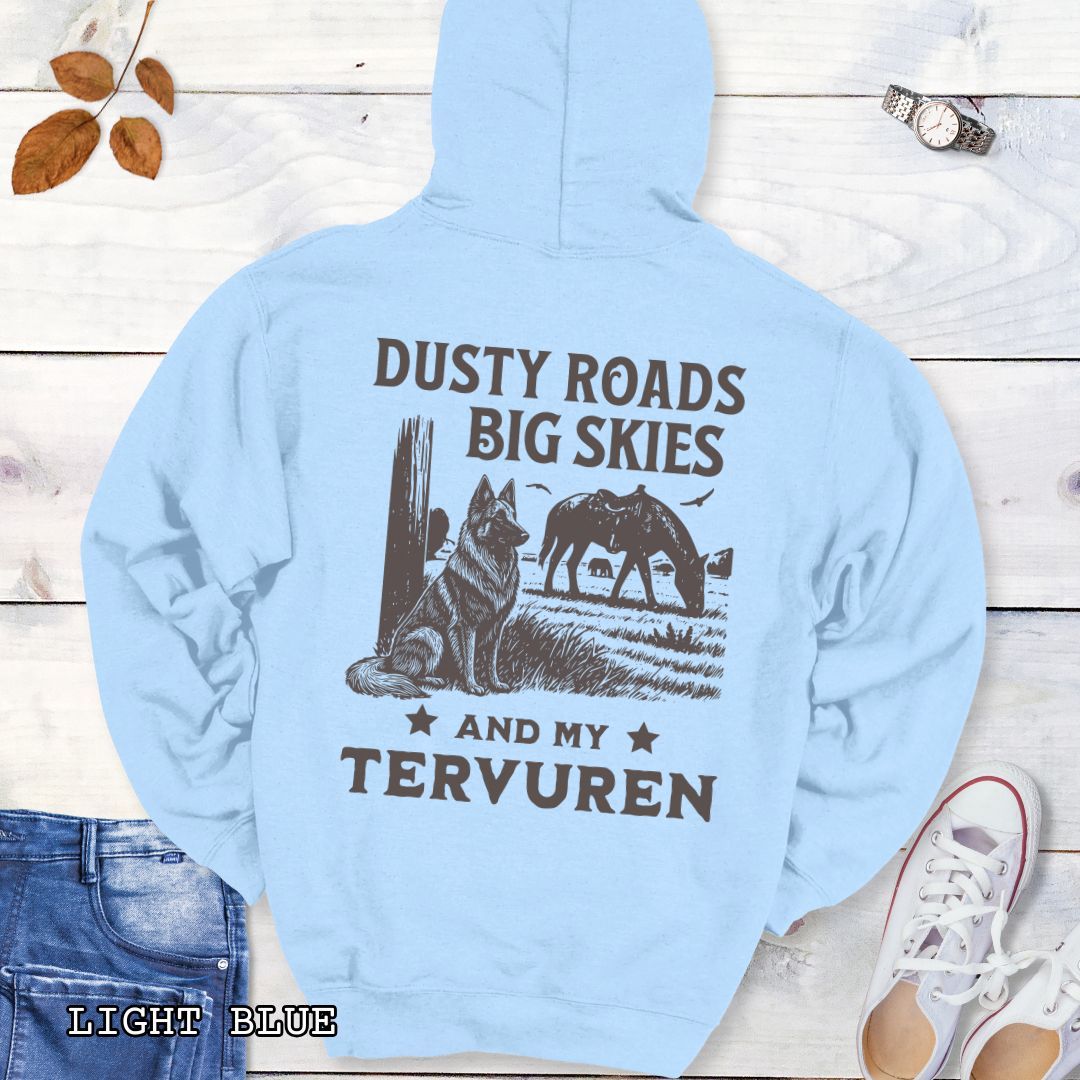 Back view of light blue hoodie featuring a Western-style design with grazing horse, rustic fence, and a Belgian Tervuren illustration; text reads “Dusty Roads, Big Skies, and My Tervuren.”