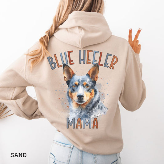 Beige Australian Cattle Dog hoodie with blue heeler graphic and 'Blue Heeler Mama' multicolor text on the back, on a white background