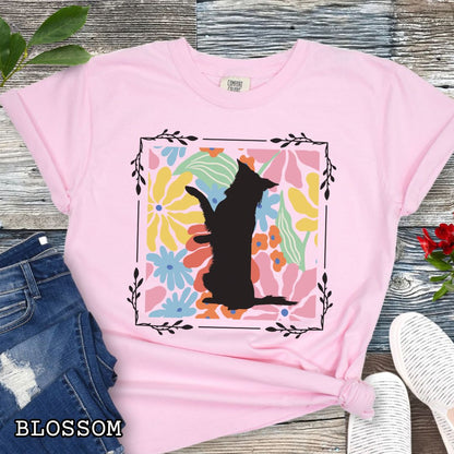 Pink Comfort Colors t-shirt with a Border Collie silhouette framed by colorful, Boho-style flowers and foliage. Displayed with jeans and a flower.