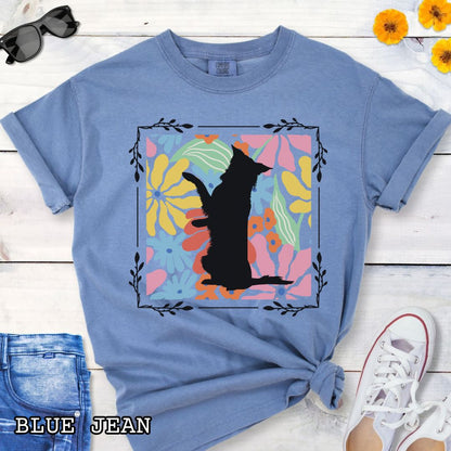 Blue Comfort Colors t-shirt with a Border Collie silhouette framed by colorful, Boho-style flowers and foliage. Displayed with jeans and a flower.