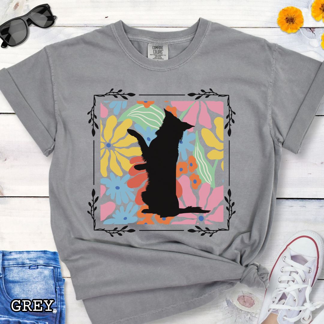 Grey Comfort Colors t-shirt with a Border Collie silhouette framed by colorful, Boho-style flowers and foliage. Displayed with jeans and a flower.