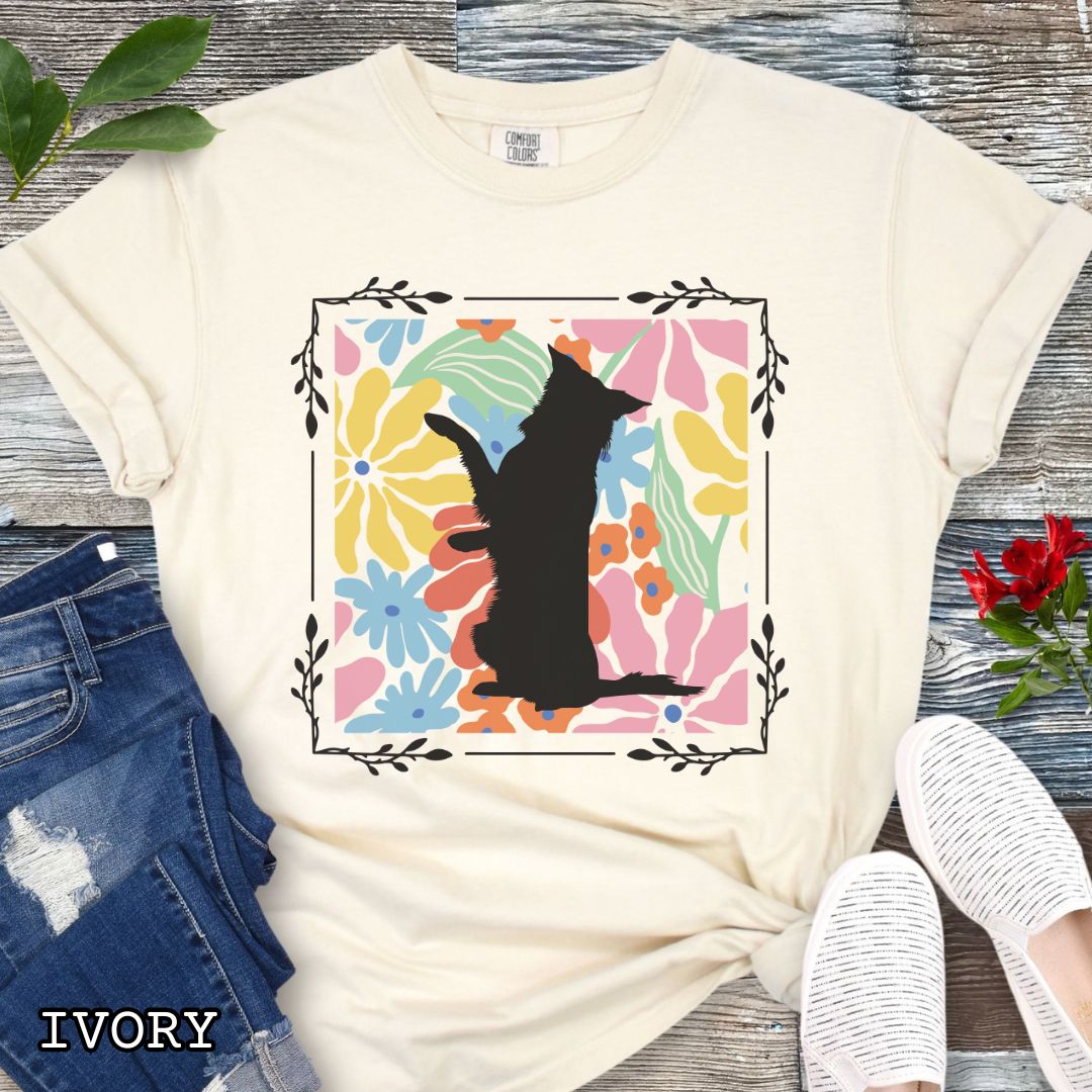 Beige Comfort Colors t-shirt with a Border Collie silhouette framed by colorful, Boho-style flowers and foliage. Displayed with jeans and a flower.