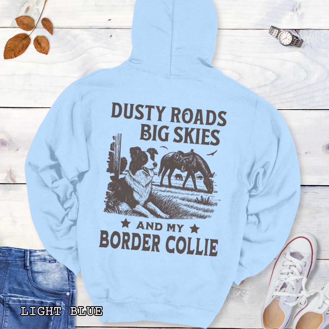 Back view of light blue Border Collie hoodie featuring a Western-style design with grazing horse, rustic fence, and an Border Collie illustration; text reads “Dusty Roads, Big Skies, and My Border Collie.”