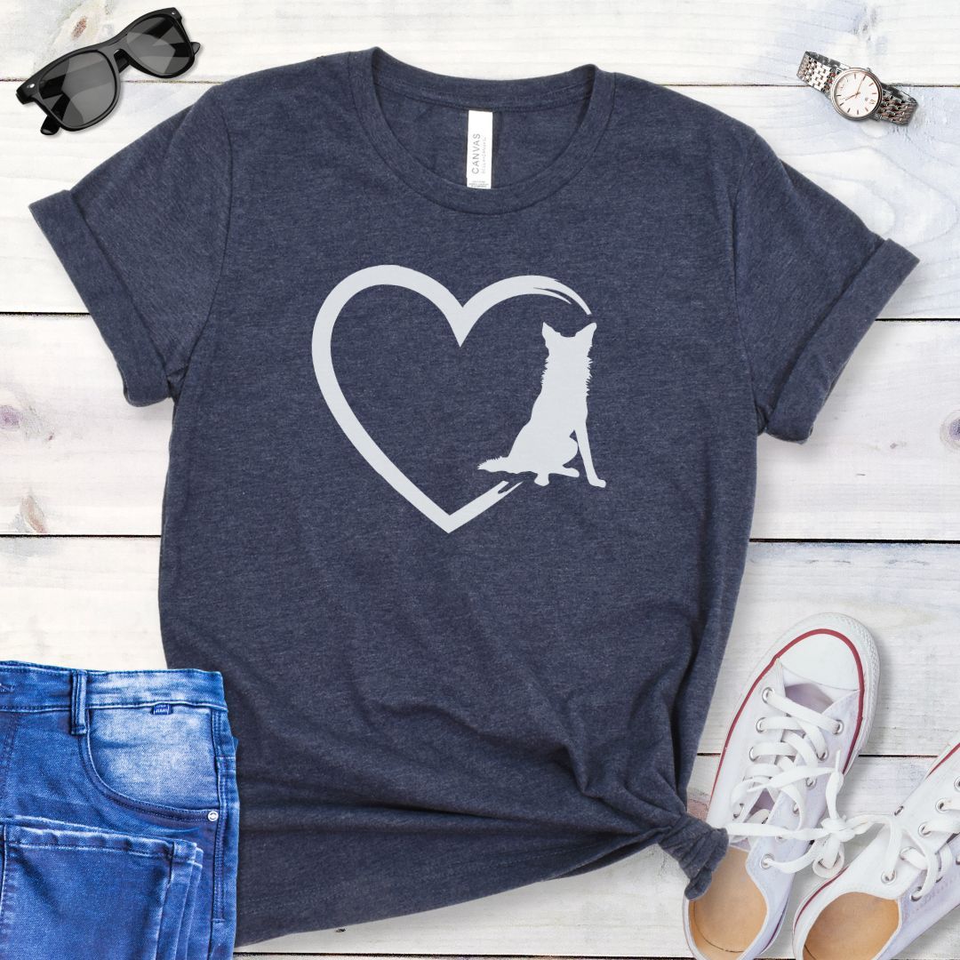 Heather navy t-shirt for Border Collie lovers with a sketched heart intersected by a sitting Border Collie dog, shown on a wooden surface with jeans and shoes.