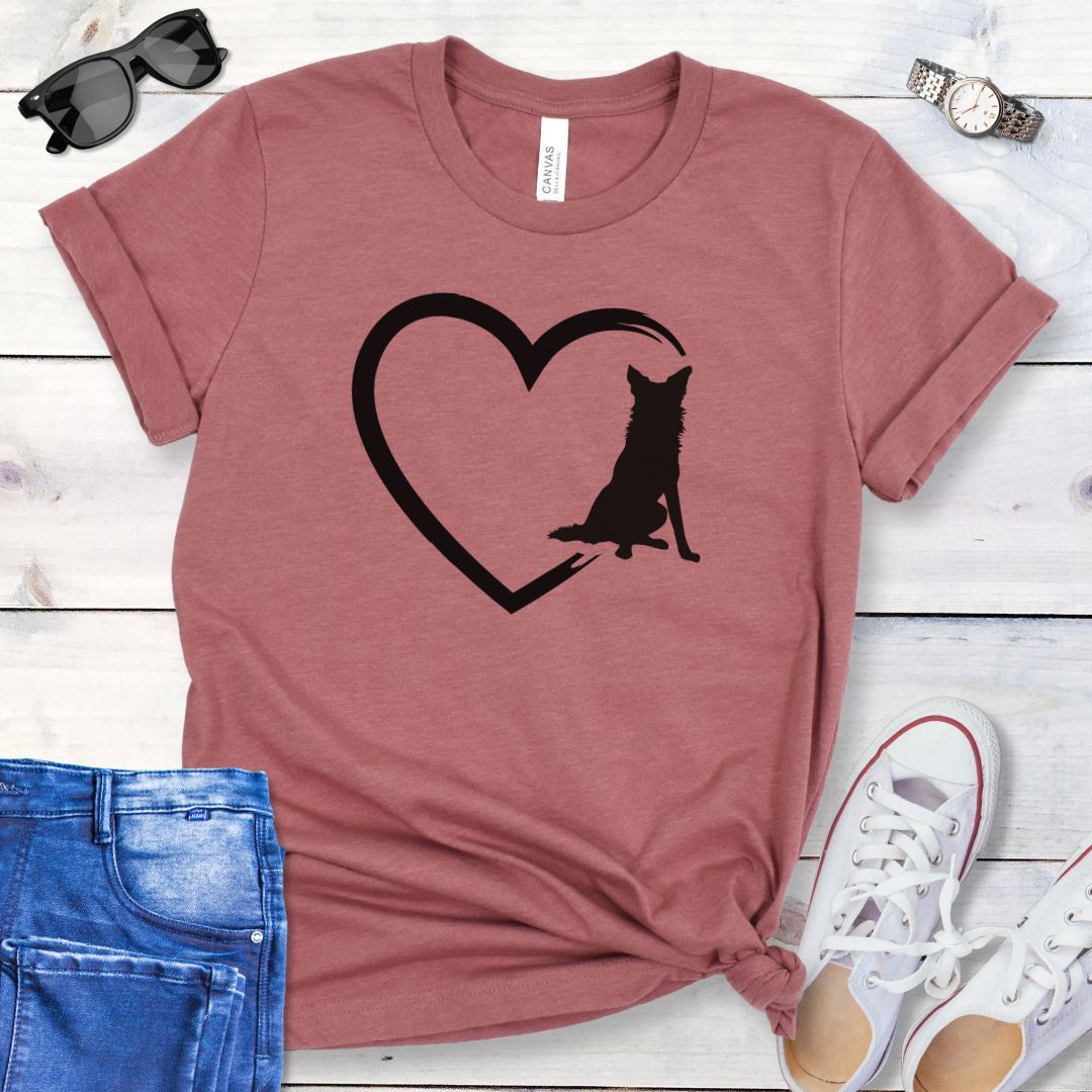 Mauve t-shirt for Border Collie lovers with a sketched heart intersected by a sitting Border Collie dog, shown on a wooden surface with jeans and shoes.