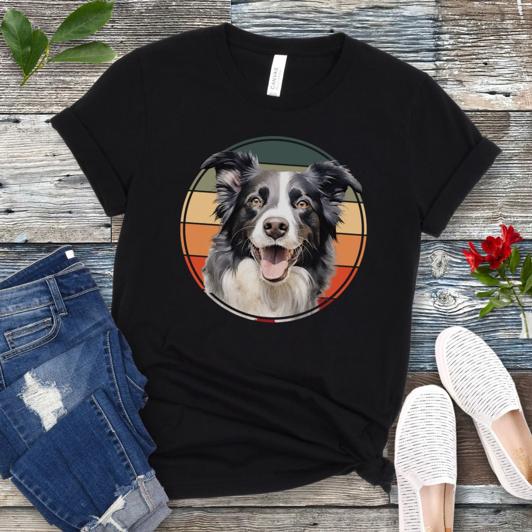 Black t-shirt for Border Collie lovers with a Border Collie face in a vintage style retro sunset graphic. Presented on a wooden surface with jeans and sneakers.