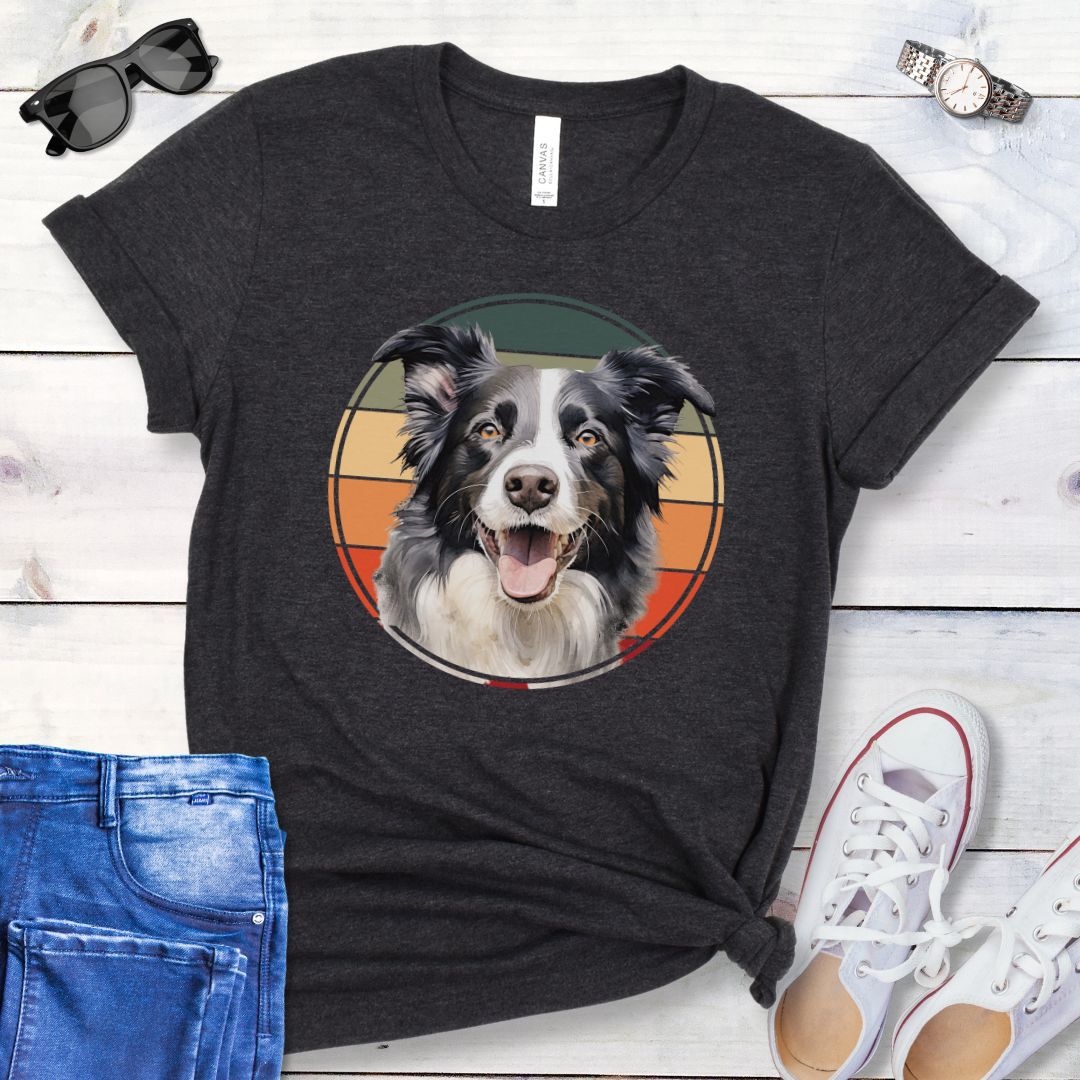 Dark grey t-shirt for Border Collie lovers with a Border Collie face in a vintage style retro sunset graphic. Presented on a wooden surface with jeans and sneakers.
