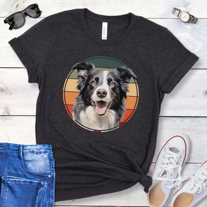 Dark grey t-shirt for Border Collie lovers with a Border Collie face in a vintage style retro sunset graphic. Presented on a wooden surface with jeans and sneakers.