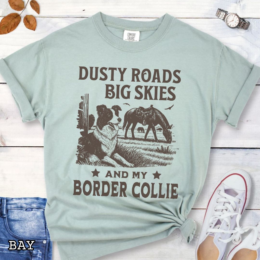 Light green Comfort Colors Border Collie t-shirt featuring a Western-style design with grazing horse, rustic fence, and an Border Collie illustration; text reads “Dusty Roads, Big Skies, and My Border Collie.”