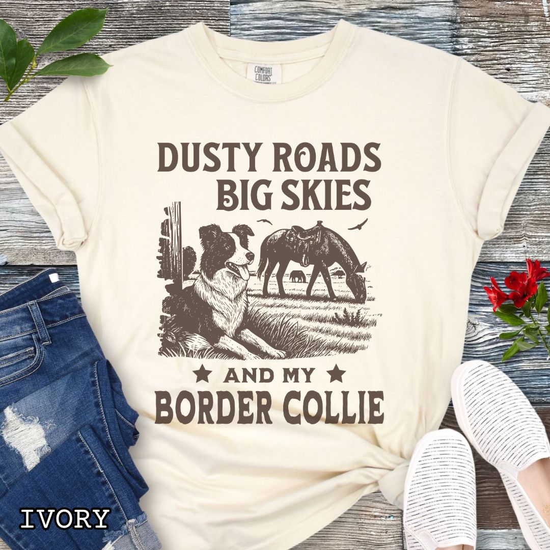 Beige Comfort Colors Border Collie t-shirt featuring a Western-style design with grazing horse, rustic fence, and an Border Collie illustration; text reads “Dusty Roads, Big Skies, and My Border Collie.”