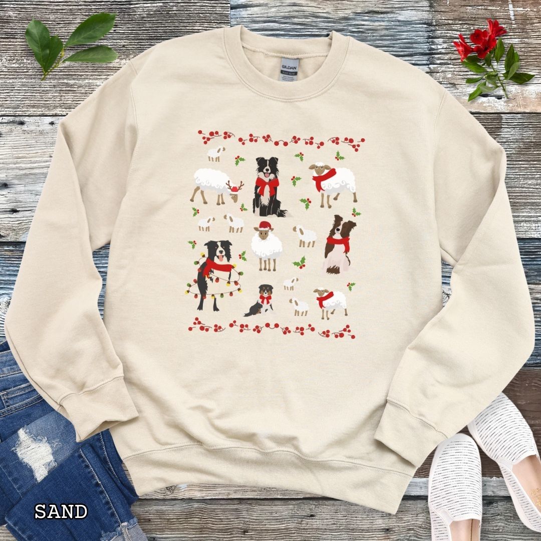 Sand Gildan 18000 Border Collies and Sheep Christmas sweatshirt featuring festive sheep, Border Collies, Santa hats, scarves, and holly for herding dog lovers.
