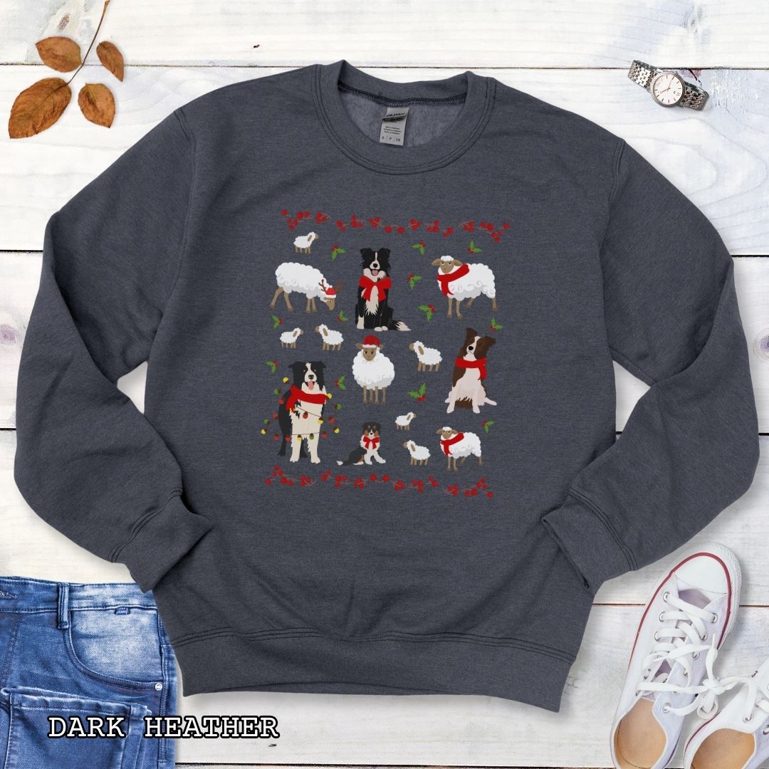 Dark grey Gildan 18000 Border Collies and Sheep Christmas sweatshirt featuring festive sheep, Border Collies, Santa hats, scarves, and holly for herding dog lovers.