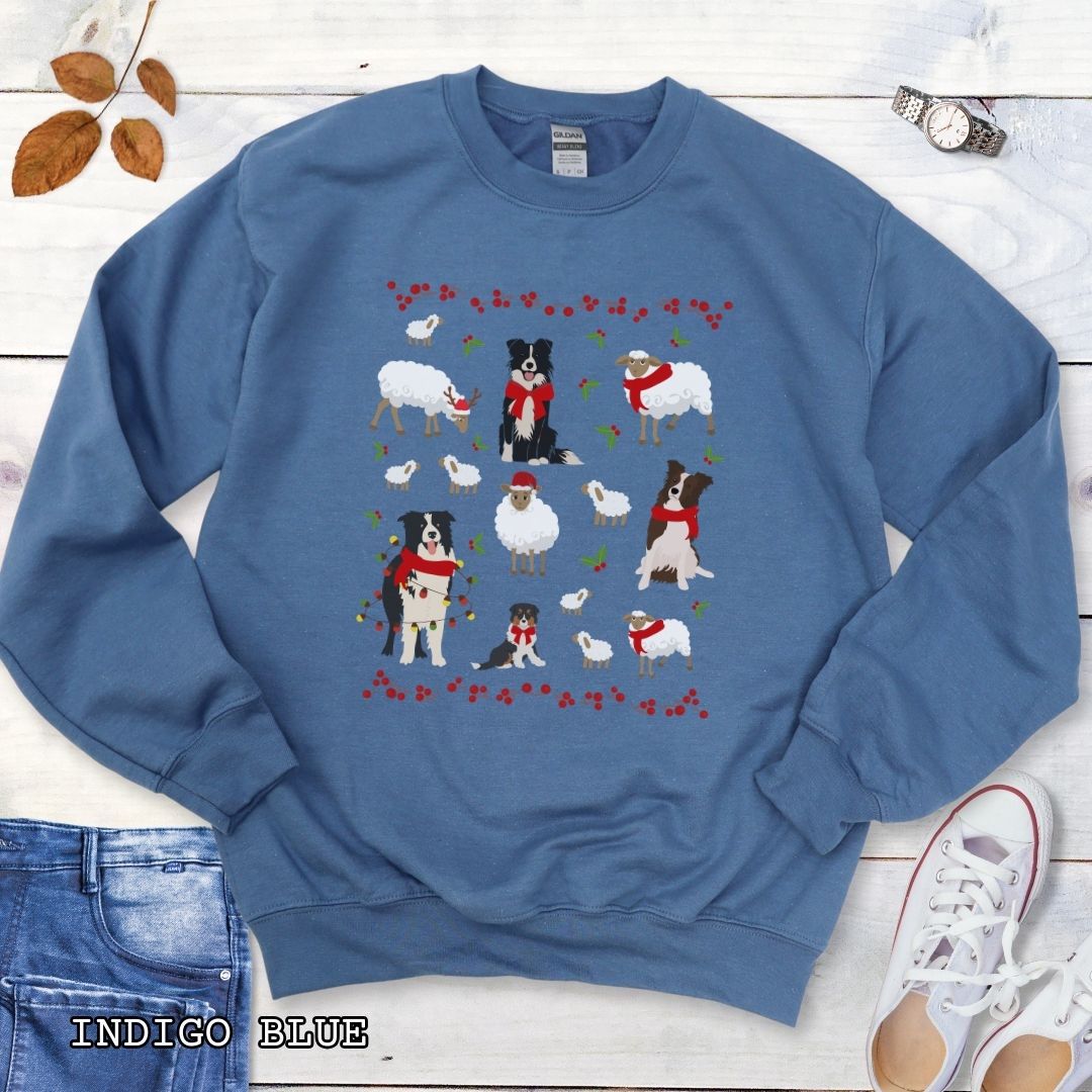 Indigo Blue Gildan 18000 Border Collies and Sheep Christmas sweatshirt featuring festive sheep, Border Collies, Santa hats, scarves, and holly for herding dog lovers.