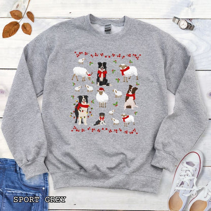 Grey Gildan 18000 Border Collies and Sheep Christmas sweatshirt featuring festive sheep, Border Collies, Santa hats, scarves, and holly for herding dog lovers.