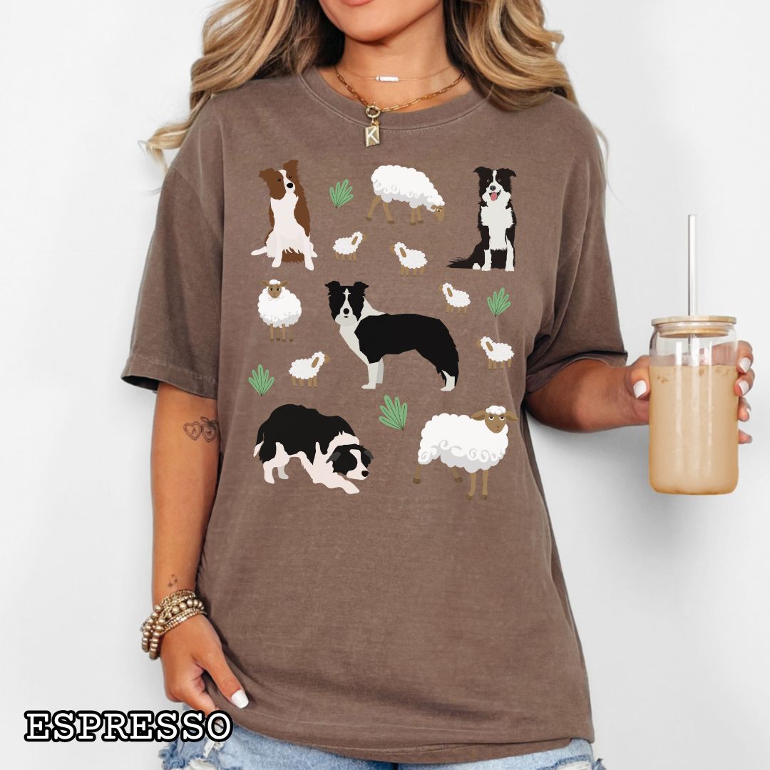 Brown Comfort Colors  t-shirt with Border Collie dogs and grazing sheep, done in Cottage Core style, shown on a wooden surface with sunglasses and flowers.