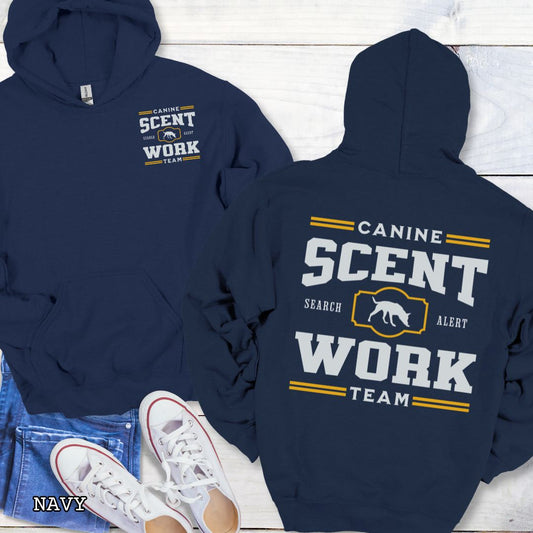 Navy back print hoodie with 'Canine Scent Work Team' text on a wooden surface.