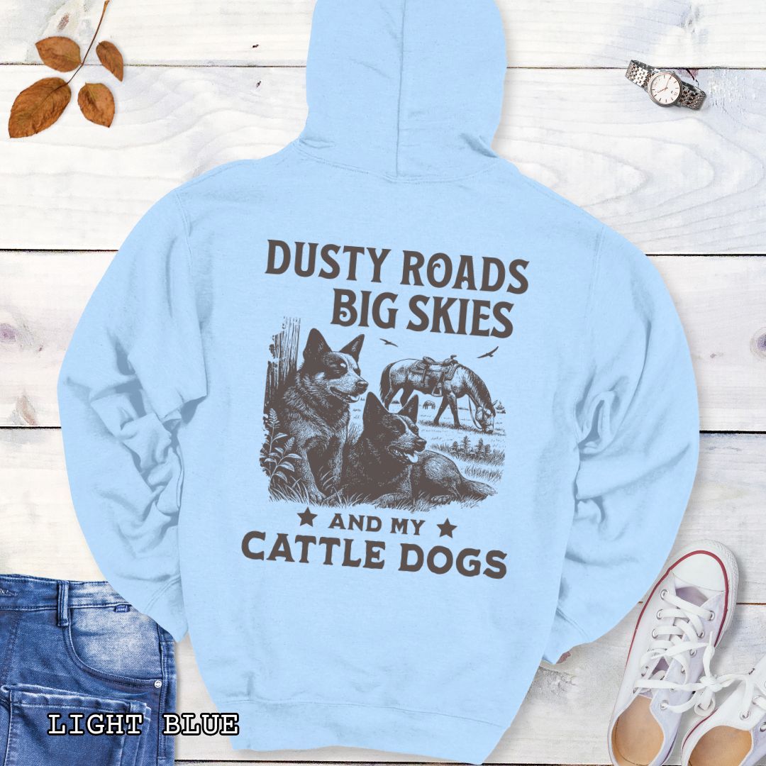 Back view of light blue Blue Heeler hoodie featuring a Western-style design with grazing horse, rustic fence, and Cattle Dog illustration; text reads “Dusty Roads, Big Skies, and My Cattle Dogs.”