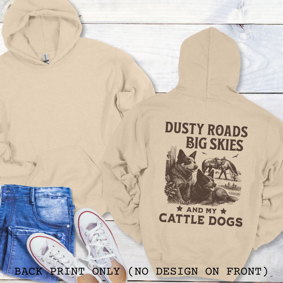 Back view of sand-beige Blue Heeler hoodie featuring a Western-style design with grazing horse, rustic fence, and Cattle Dog illustration; text reads “Dusty Roads, Big Skies, and My Cattle Dogs.”