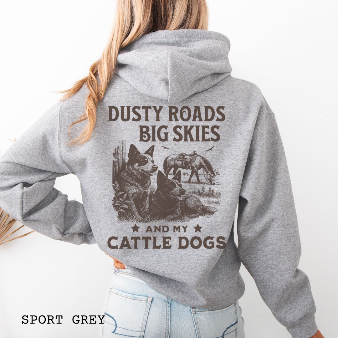 Back view of grey Blue Heeler hoodie featuring a Western-style design with grazing horse, rustic fence, and Cattle Dog illustration; text reads “Dusty Roads, Big Skies, and My Cattle Dogs.”