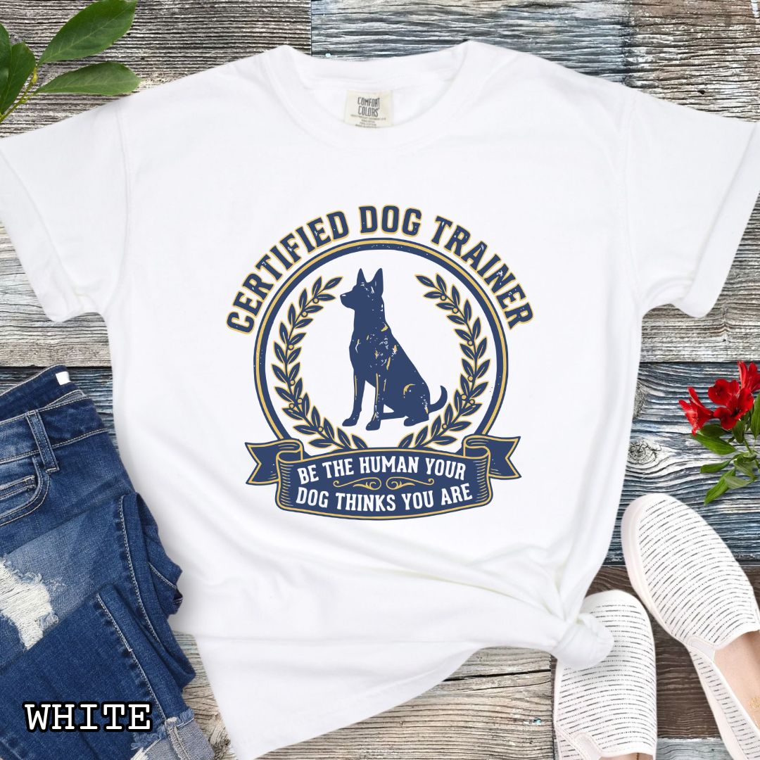 White Comfort Colors t-shirt featuring a Certified Dog Trainer design with dog silhouette and Be the Human Your Dog Thinks You Are message, professional dog trainer shirt for canine trainers, obedience instructors, and dog training professionals.