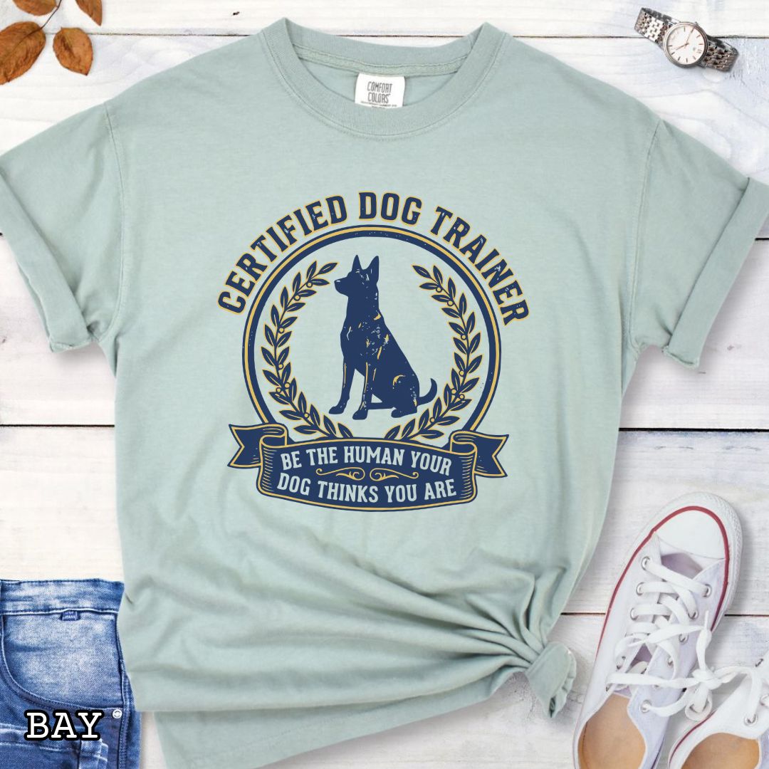 Light green Comfort Colors t-shirt featuring a Certified Dog Trainer design with dog silhouette and Be the Human Your Dog Thinks You Are message, professional dog trainer shirt for canine trainers, obedience instructors, and dog training professionals.