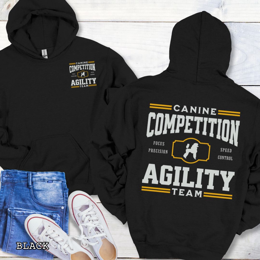 Black dog agility hoodie with 'Canine Competition Agility Team' text and custom breed silhouette, presented graphics on a wooden surface.