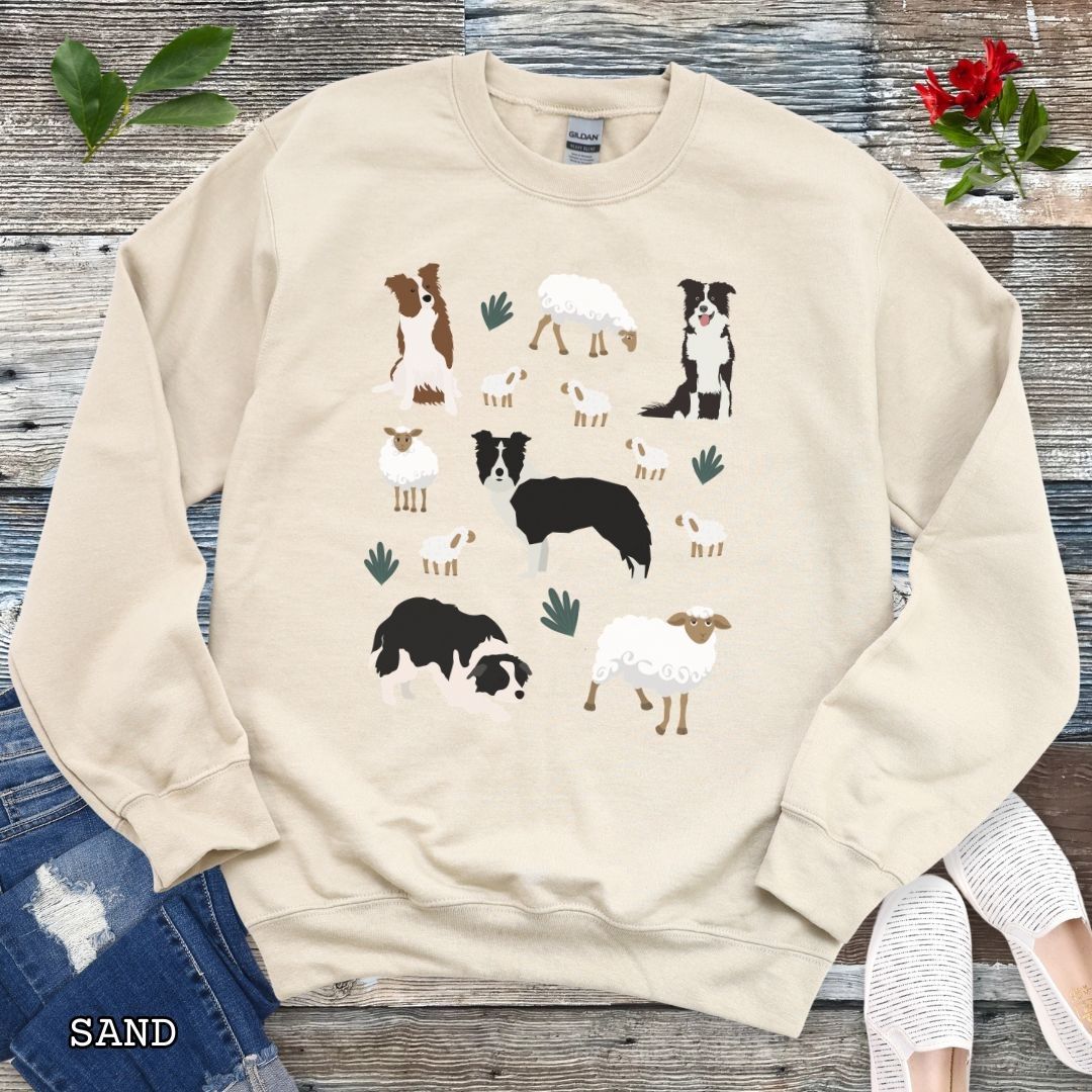 Sand colored unisex sweatshirt with cottagecore Border Collies and Sheep design featuring playful Border Collie herding dogs, fluffy sheep, and countryside artwork for sheepdog handlers, herding dog trainers, and Border Collie lovers.