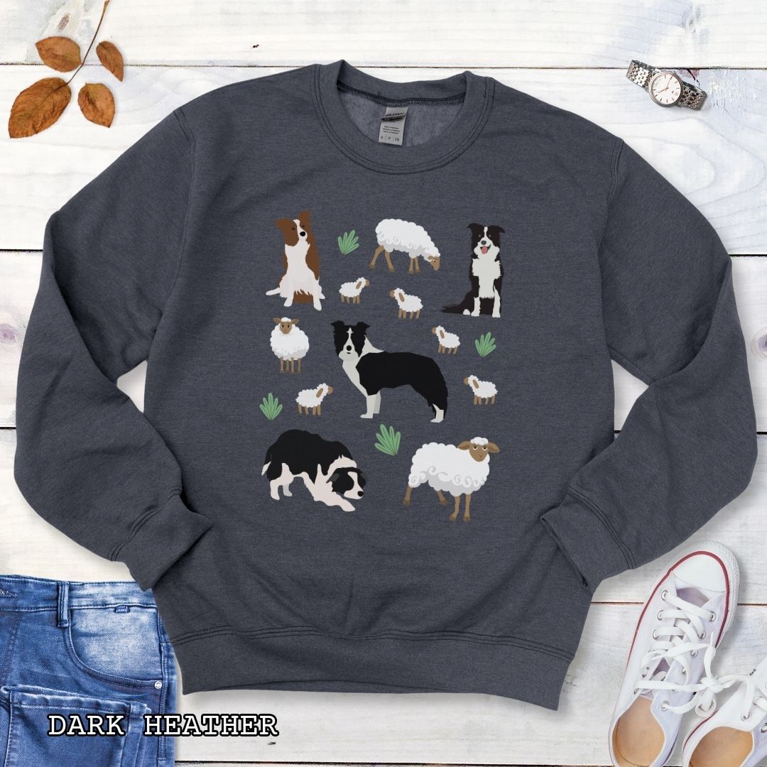 Dark heather grey unisex sweatshirt with cottagecore Border Collies and Sheep design featuring playful Border Collie herding dogs, fluffy sheep, and countryside artwork for sheepdog handlers, herding dog trainers, and Border Collie lovers.