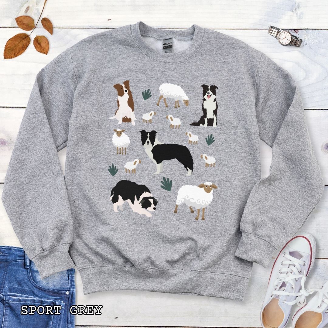 Heather grey unisex sweatshirt with cottagecore Border Collies and Sheep design featuring playful Border Collie herding dogs, fluffy sheep, and countryside artwork for sheepdog handlers, herding dog trainers, and Border Collie lovers.