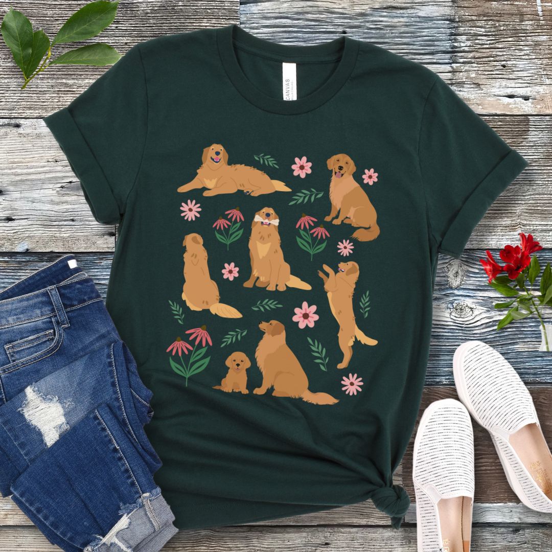 Dark green dog lover t-shirt with cottagecore-style design made of Golden Retriever dogs in various positions, accented by flowers and leaves, shown on a wooden surface with jeans and shoes.
