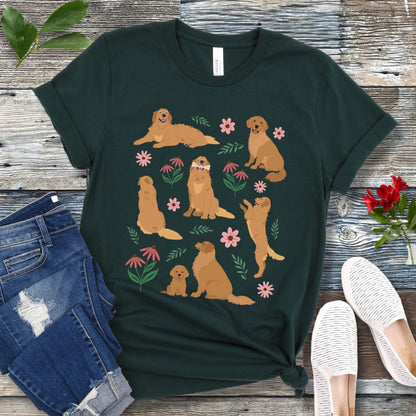 Dark green dog lover t-shirt with cottagecore-style design made of Golden Retriever dogs in various positions, accented by flowers and leaves, shown on a wooden surface with jeans and shoes.