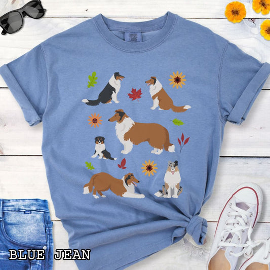Blue Comfort Colors t-shirt for Rough Collie lovers with cottagecore design of Collie dogs and floral botanical elements, shown on a wooden surface with jeans and sneakers.