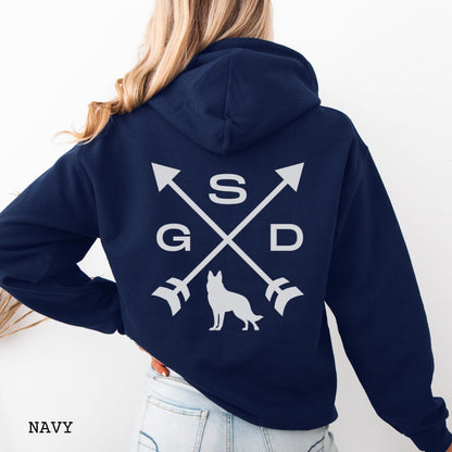 Back view of a navy blue unisex hoodie with a crossed arrows design with 'GSD' text and a German Shepherd silhouette, worn by a person.