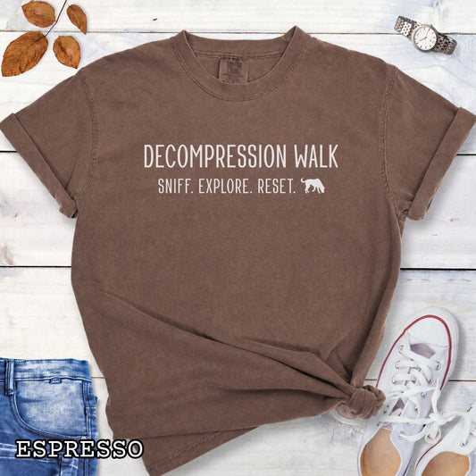 Espresso Comfort Colors Decompression Walk t-shirt featuring Sniff Explore Reset typography and a sniffing dog design for trainers, dog owners, and enrichment enthusiasts.