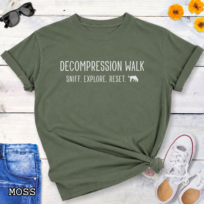 Moss green Comfort Colors Decompression Walk t-shirt featuring Sniff Explore Reset typography and a sniffing dog design for trainers, dog owners, and enrichment enthusiasts.